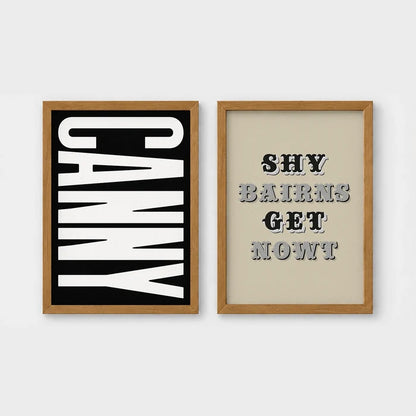 Set of 2 framed prints, Newcastle & Geordie dialect prints (black & white): the word "Canny" in bold black and white type; and the Geordie slogan "Shy Bairns Get Nowt" in bold black and white type — unframed