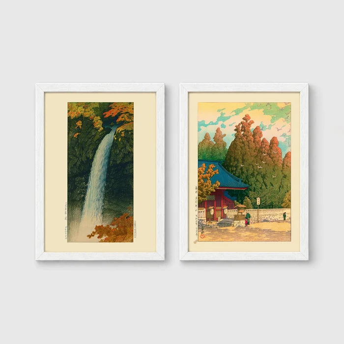 Set of 2 framed prints, Kawase Hasui Japanese woodblock prints: a waterfall cascading through autumn foliage; and a red pagoda gate in an autumn forest — unframed