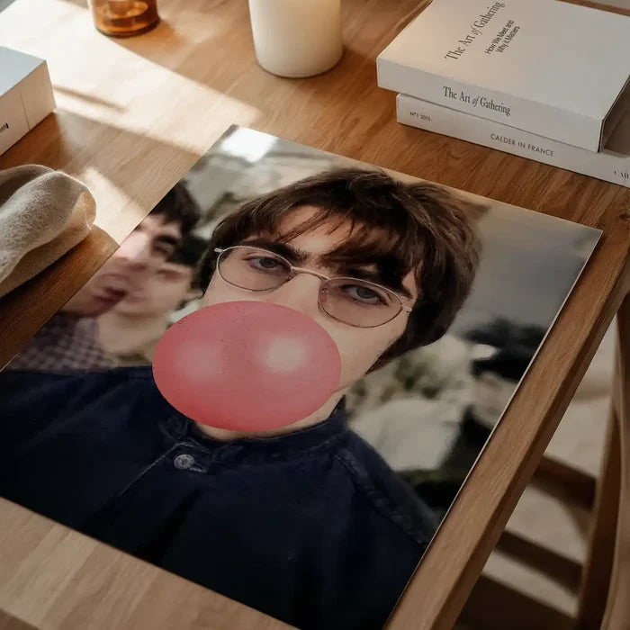 Liam Bubblegum Portrait Oasis Print, quirky altered art print unframed on a home office desk