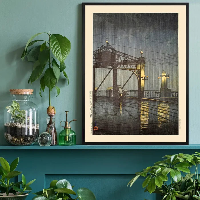Shinohashi Bridge Print by Hasui Kawase, Japanese woodblock print black framed on a living room shelf