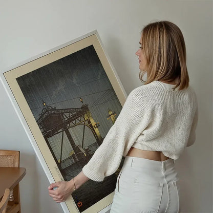 Shinohashi Bridge Print by Hasui Kawase held up against a living room wall