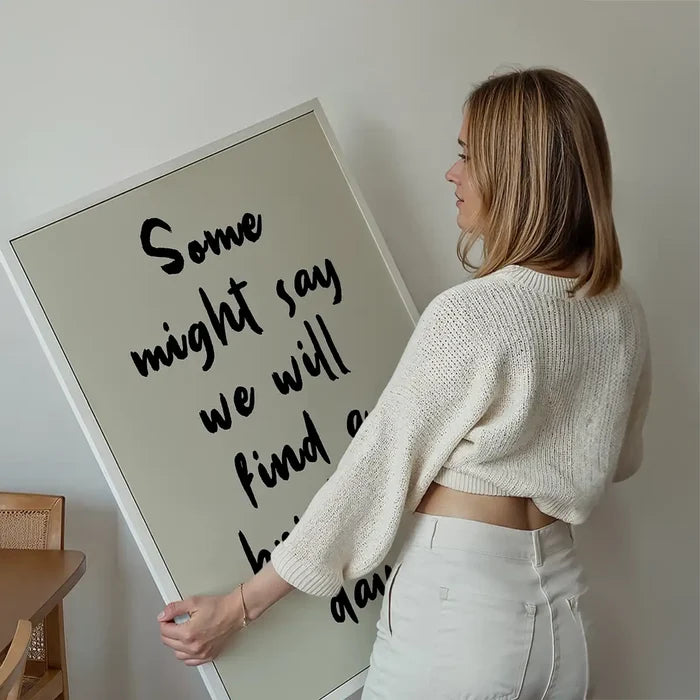 Some Might Say 2025 Oasis Lyrics Print held up against a living room wall